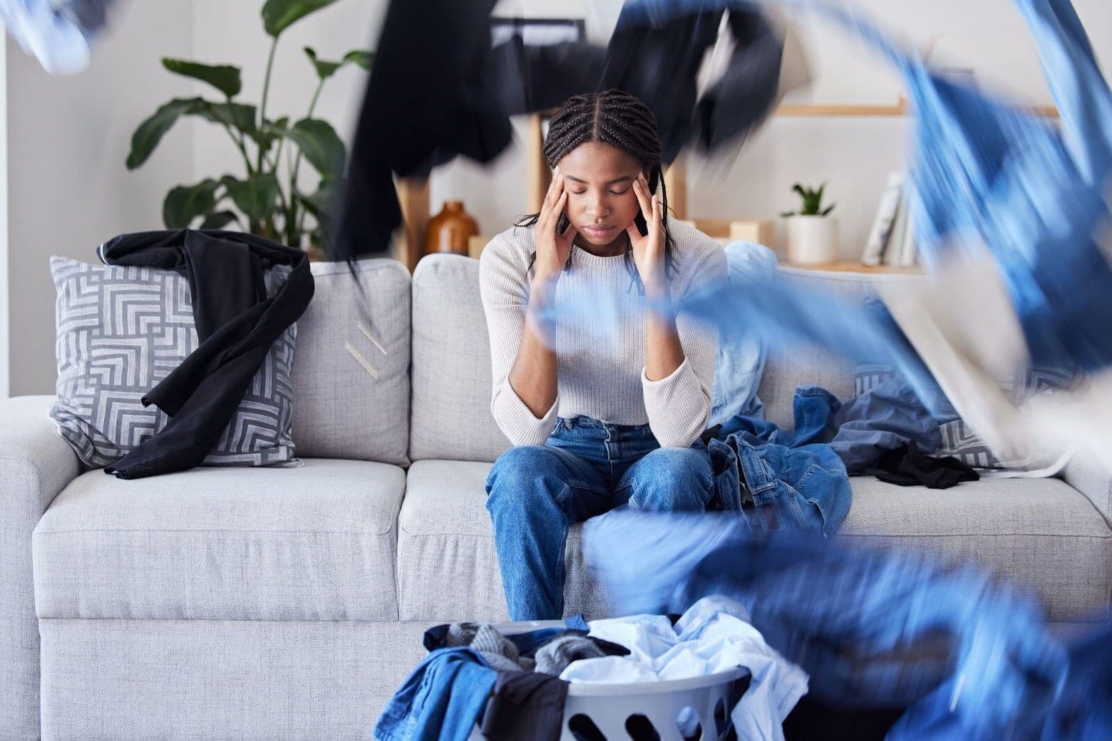 Person experiencing adhd burnout feeling overwhelmed by clutter and mental overload at home