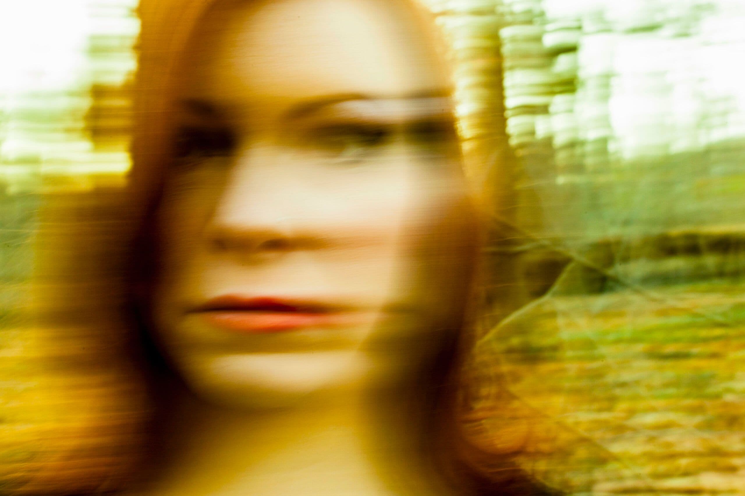 Blurry face symbolizing detachment and unreality from depersonalization-derealization disorder