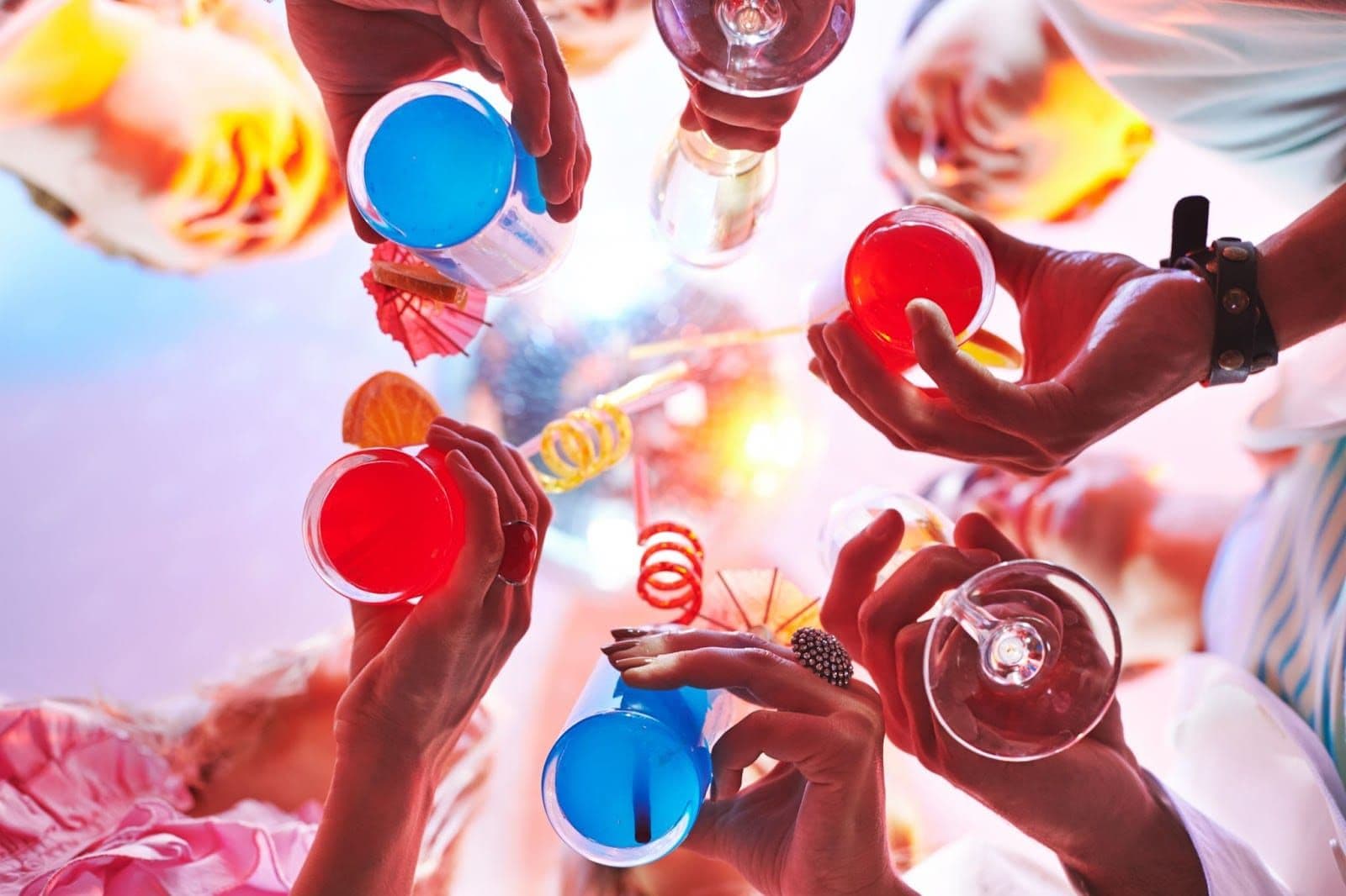 Teen alcohol use with colorful drinks at a party setting